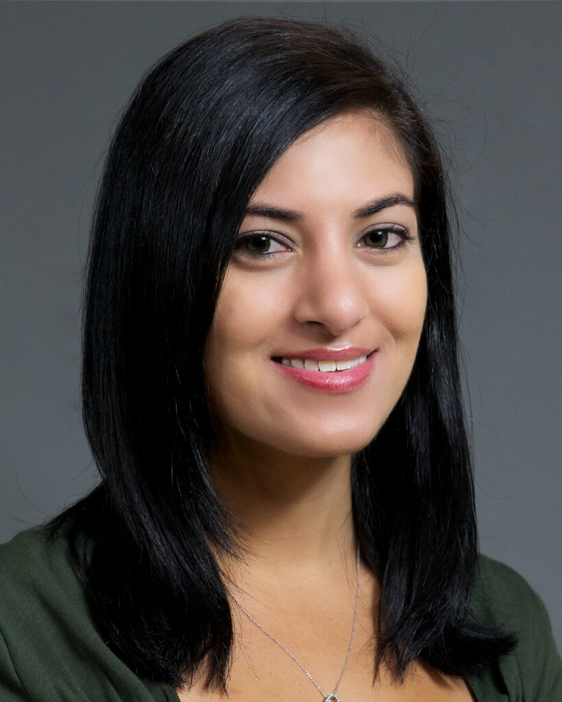 A headshot of Emily showing a woman with black hair and brown eyes.